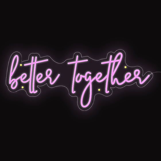 Pink neon cursive sign that says better together