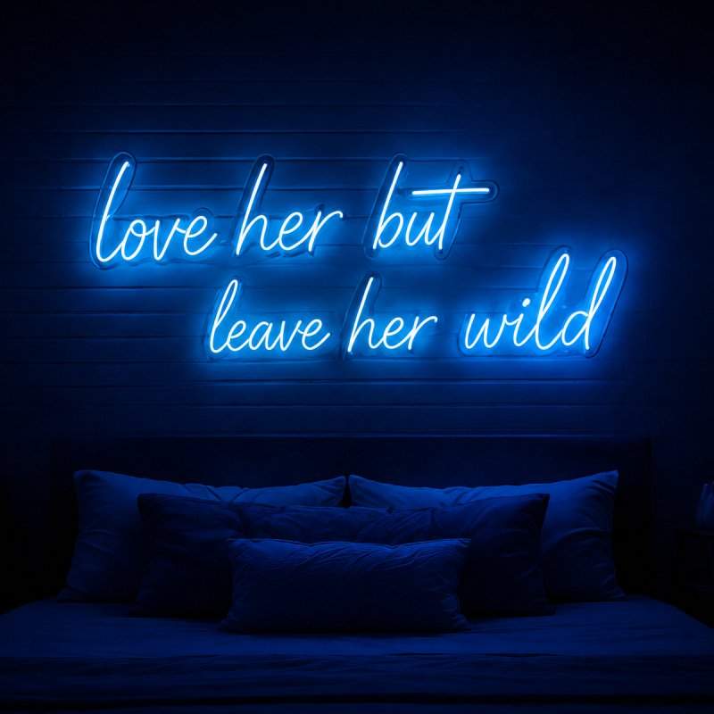 Blue cursive neon sign displayed above a bed as bedroom wall décor.