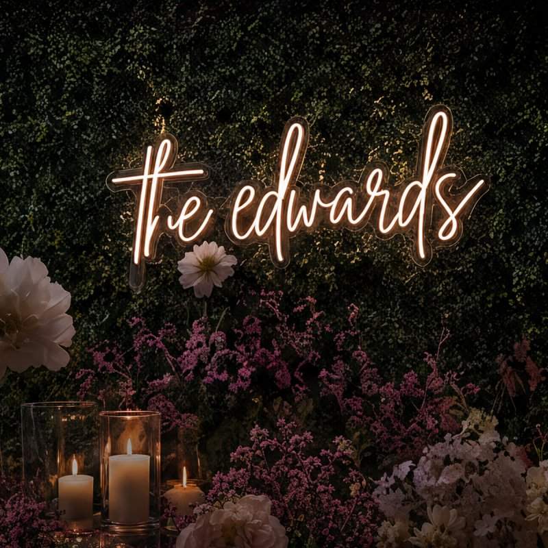 Custom wedding neon sign displayed on a floral backdrop.